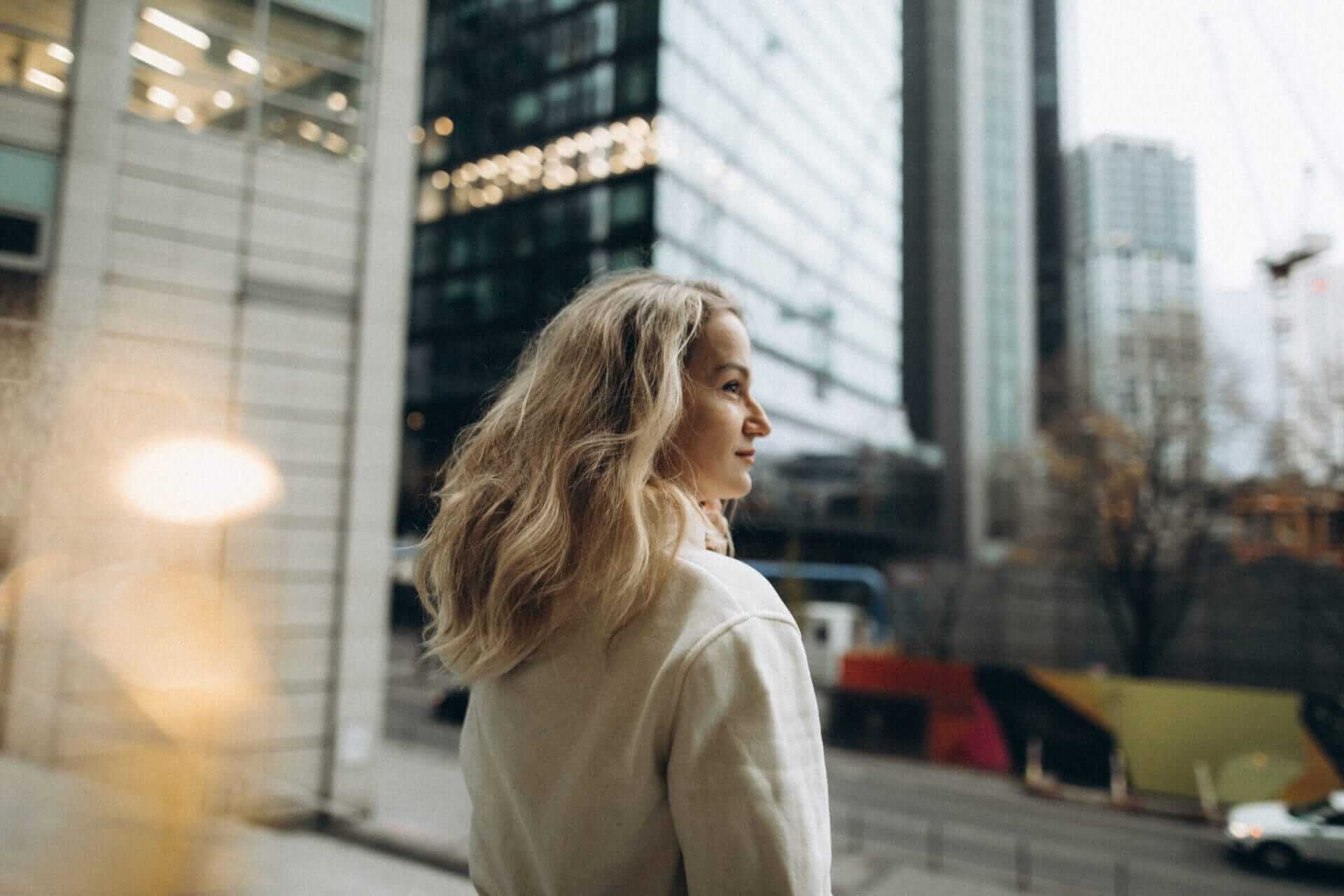 Middle-aged woman among high-rise buildings in the city - Cavendish